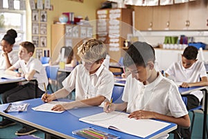 Two schoolboys working in a primary school class