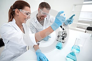 Two scientists chemists conduct research in the laboratory