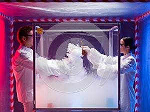 Two scientists conducting tests in sterile chamber