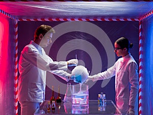 Two scientists experimenting in a containment tent