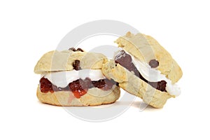 Two scones with cream and jam