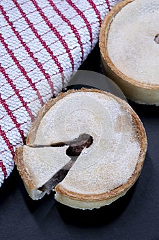 Two scotch mince or meat pies in round shell pastry just out the oven and ready to eat