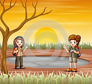 Two scout girls are exploring in dried land