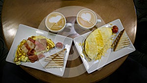 Two scrambled eggs with bacon and coffee