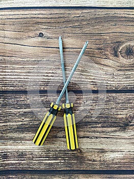 Two screwdrivers on a wooden table