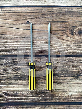 Two screwdrivers on a wooden table