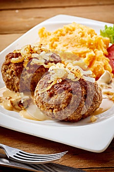 Two seasoned Bavarian frikadellen with onion photo