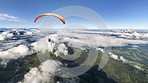 Two-seater paraglider above the clouds photo