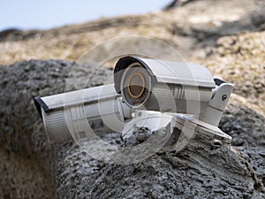 Two security cameras against blue sky