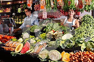 Two sellers working behind the counter photo