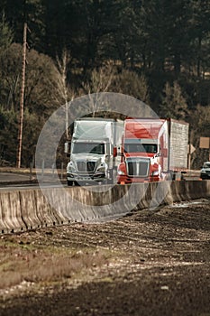 Two Semi Trucks Driving Next to Each Other on Oregon Freeway Interstate 5