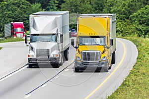 Two Semis Lead Traffic Down An Interstate Highway