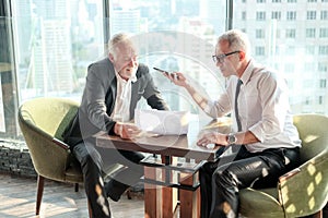 Two Senior businessman couple meeting in co working space or office