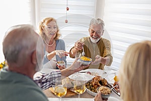 Two senior couples having Thanksgiving dinner