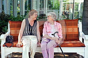 Two senior ladies enjoying a relaxing chat.