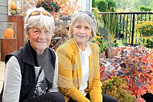 Two senior ladies seated on a patio