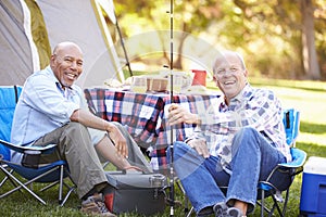 Two Senior Men On Camping Holiday With Fishing Rod