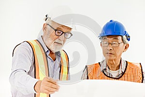 Two senior professional architecture engineer consulting with builder foreman