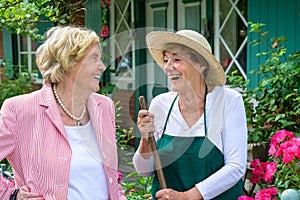 Two Senior Women Laughing Together in Garden