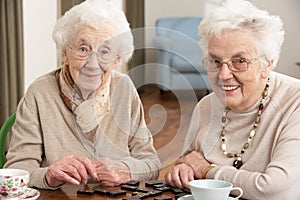 Two Senior Women Playing Dominoes photo