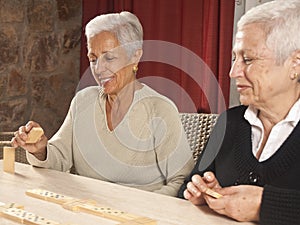 Two Senior Women Playing Dominoes