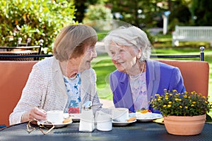 Two Senior Women Relaxing at the Outdoor Table