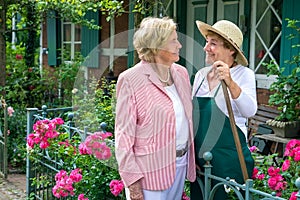 Two Senior Women Talking Together in Garden