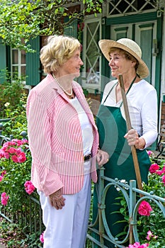 Two Senior Women Talking Together in Garden