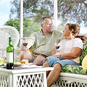 Two seniors having dinner on patio.