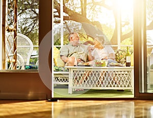 Two seniors having dinner on patio.