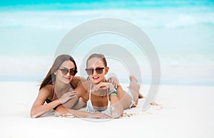 Two sensual women in bikini on a beach