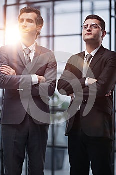 Two men business workers standing with arms crossed gesture at office