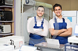 Two servicemen smiling at shop