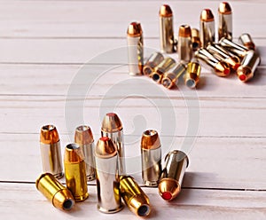 Two sets of 40 caliber bullets and 44 special bullets on a white wooden background