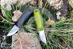 Two sharp knives. Knives with a fixed blade. Photo on stone and grass.