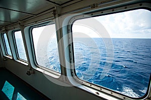 Two ship windows with ocean surface and underwater deep