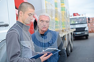 two shipping company workers at container yard