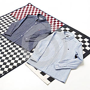 Two shirts on checkered surface isolated on white background photo