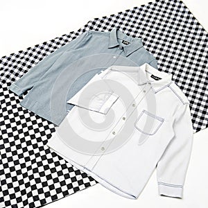 Two shirts on checkered surface isolated on white background