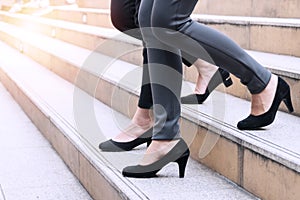 two shoes legs of businesswoman walking stepping down stair in modern city hurry time, People walk rush hour to work in