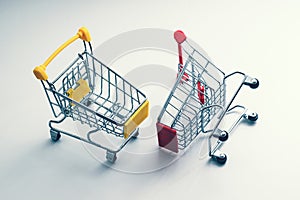 Two shopping carts - business metaphor - trade war, rivalry of markets, competition concept