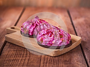 Two shortbread cakes with currant marshmallows on a kitchen board