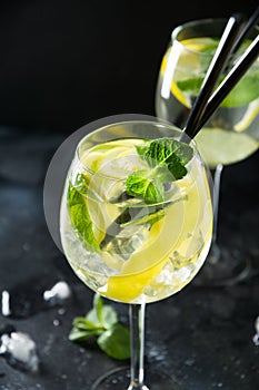 Two shot of mojito cocktail in glass on black table. Close up