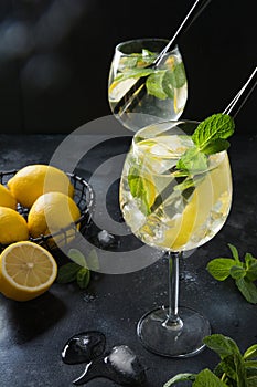 Two shot of mojito cocktail in glass on black table. Close up