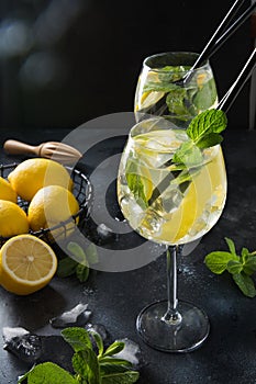 Two shot of mojito cocktail in glass on black table. Close up