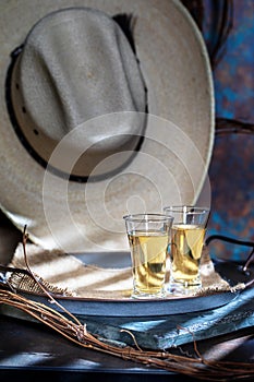 Two Shots of Tequila Rustic Setting with Cowboy Hat