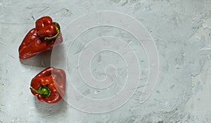 Two ugly fresh red peppers on a gray stone background. Horizontally, with space, top view photo
