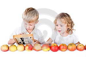 Two siblings counting apples on whit