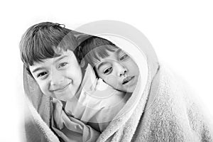 Two siblings share their blanky in cold winter