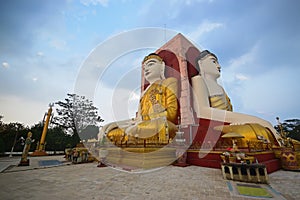 Two sides of Buddha of Kyaik Pun Pagoda Bago meditating